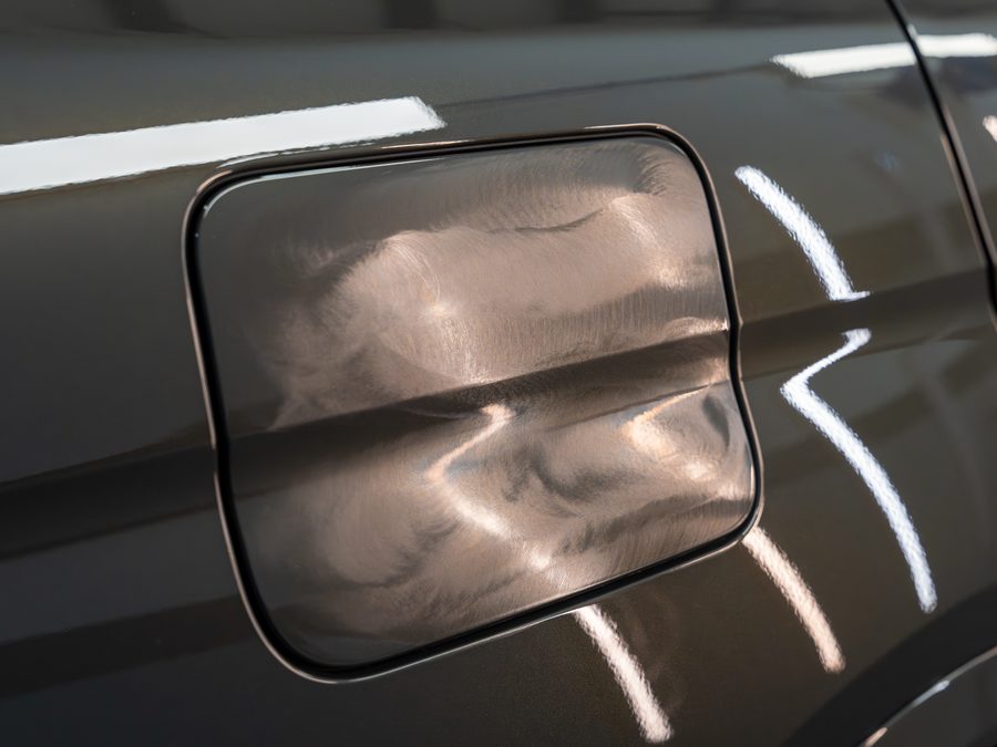 Swirl marks on a fuel door under inspection lights