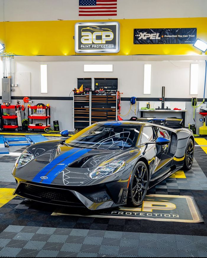 A Ford GT under the ACP sign and XPEL banner in the studio