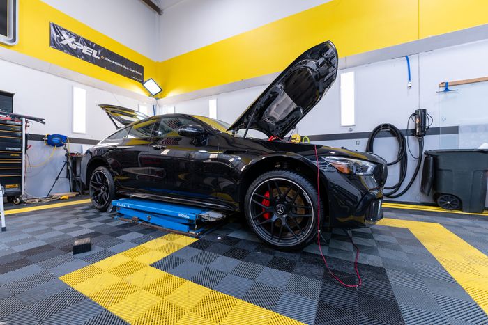 A gloss black GT 63 with its hood up in the ACP bay