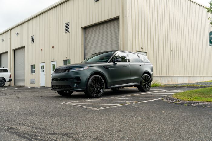 A satin green Range Rover outside a studio unit
