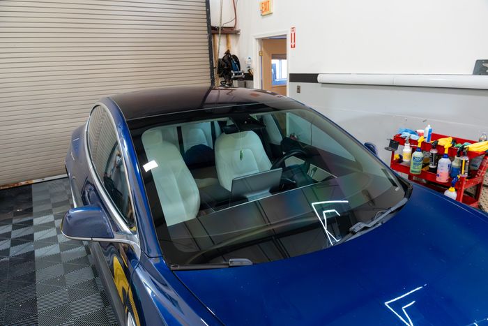 A blue Tesla Model 3 windshield in the ACP bay