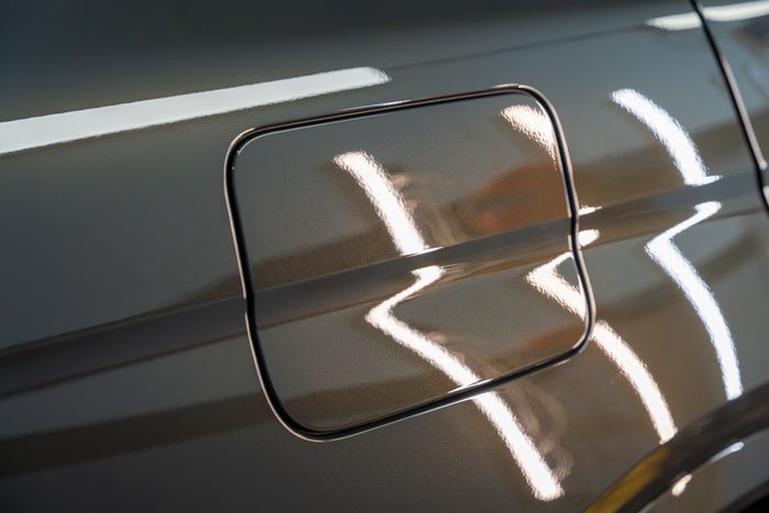 A corrected BMW fuel door with crisp reflections