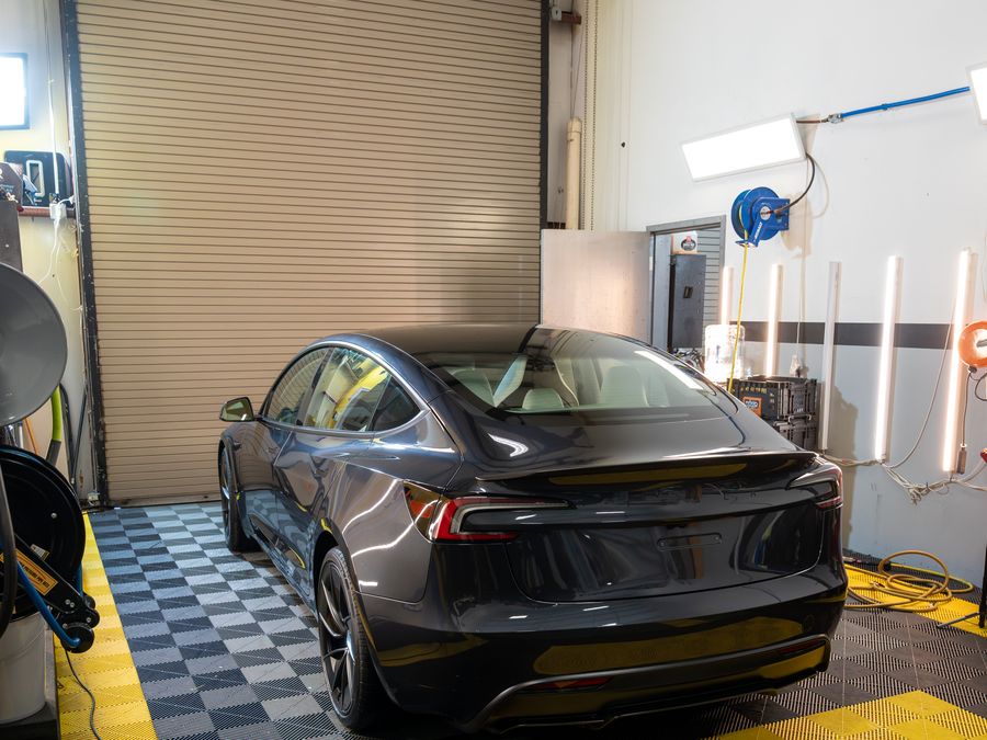 A grey Tesla Model 3 parked in the ACP bay
