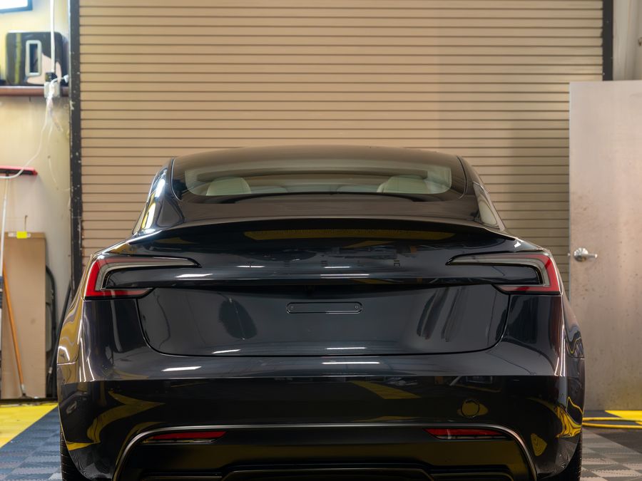 The grey Model 3 from behind in the ACP bay