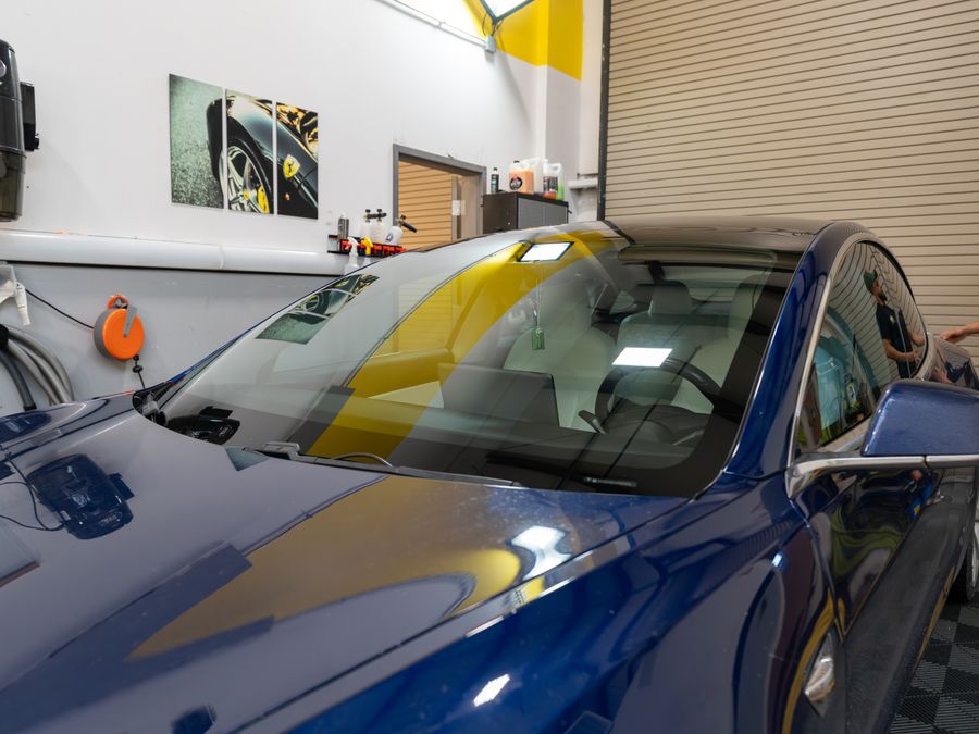 Film laid across the outside of a Tesla windshield in the ACP bay